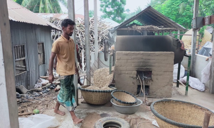 নিজের উদ্ভাবিত বাদামভাজা যন্ত্রে স্বচ্ছল রাজু